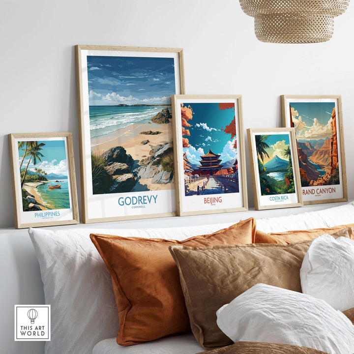 Framed travel art prints showcasing Godrevy Beach, along with destinations like Philippines and Beijing, on a cozy sofa.