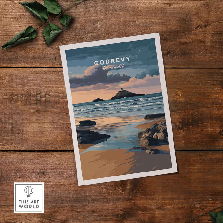 Godrevy Lighthouse art print showcasing the serene Cornish coastline on a wooden table with greenery.