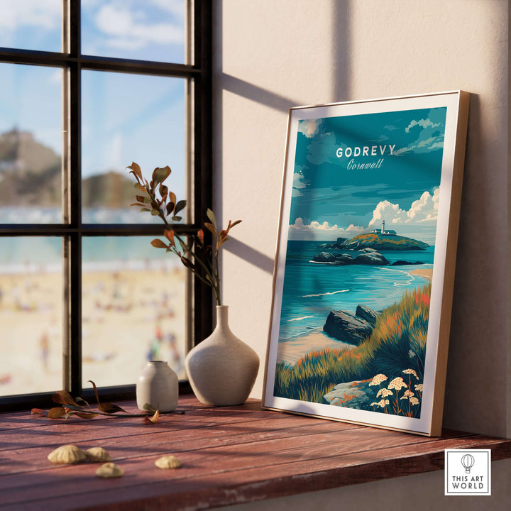 Godrevy poster featuring Cornish coast seascape art print displayed on a sunny windowsill with beach view.