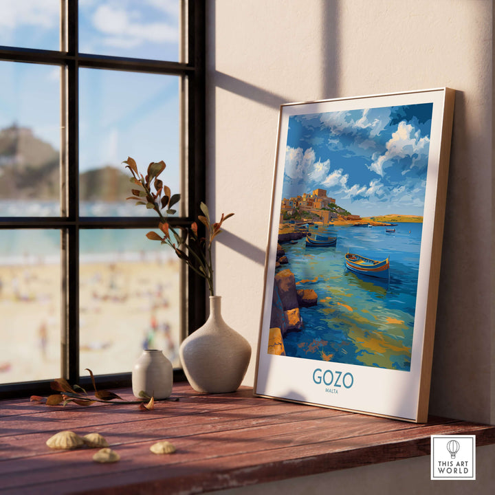 Gozo Malta Coastal Village Art Print | Traditional Boats Poster displayed on a windowsill with a beach view.