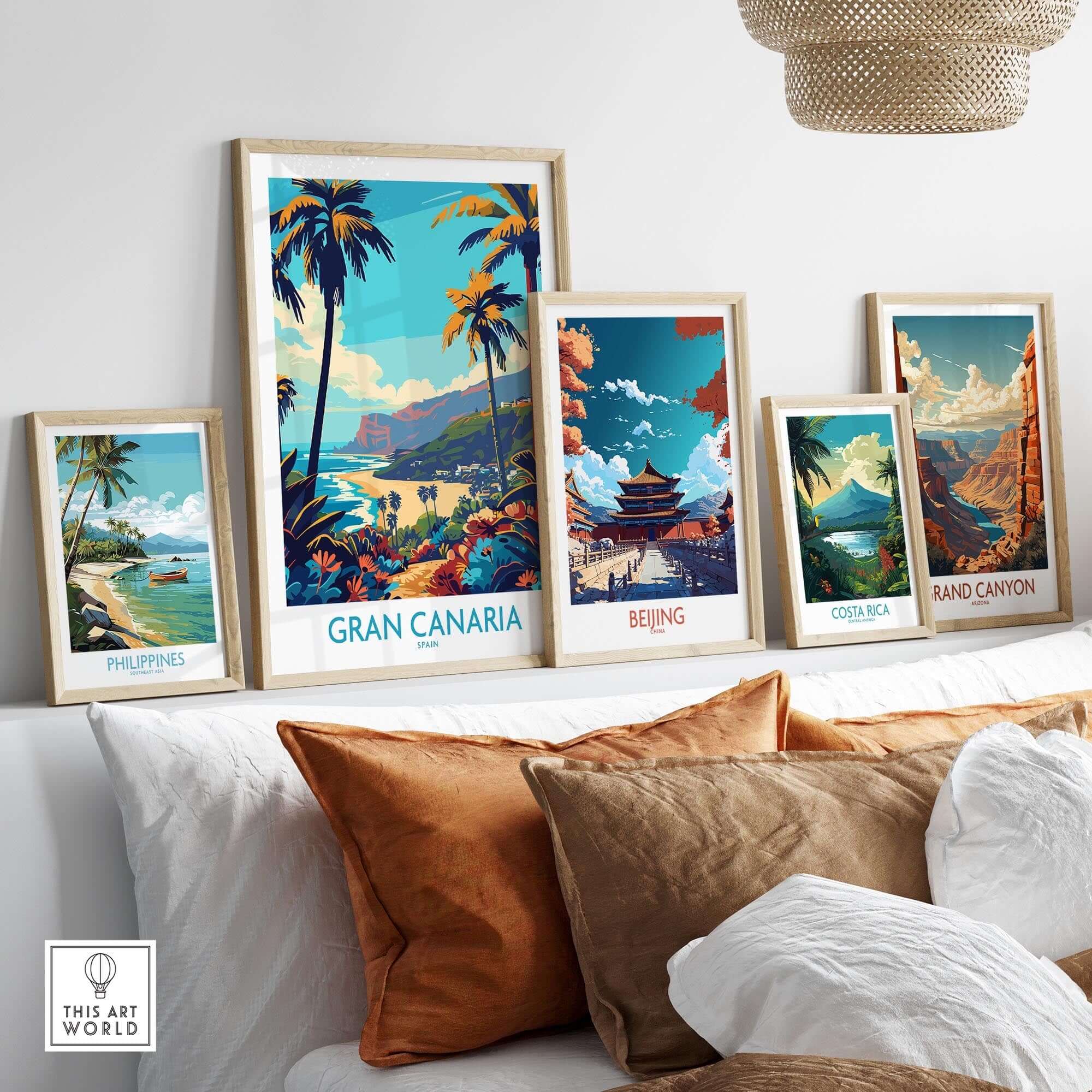 Gran Canaria Travel Poster - Canary Islands displayed among other travel prints on a cozy sofa.