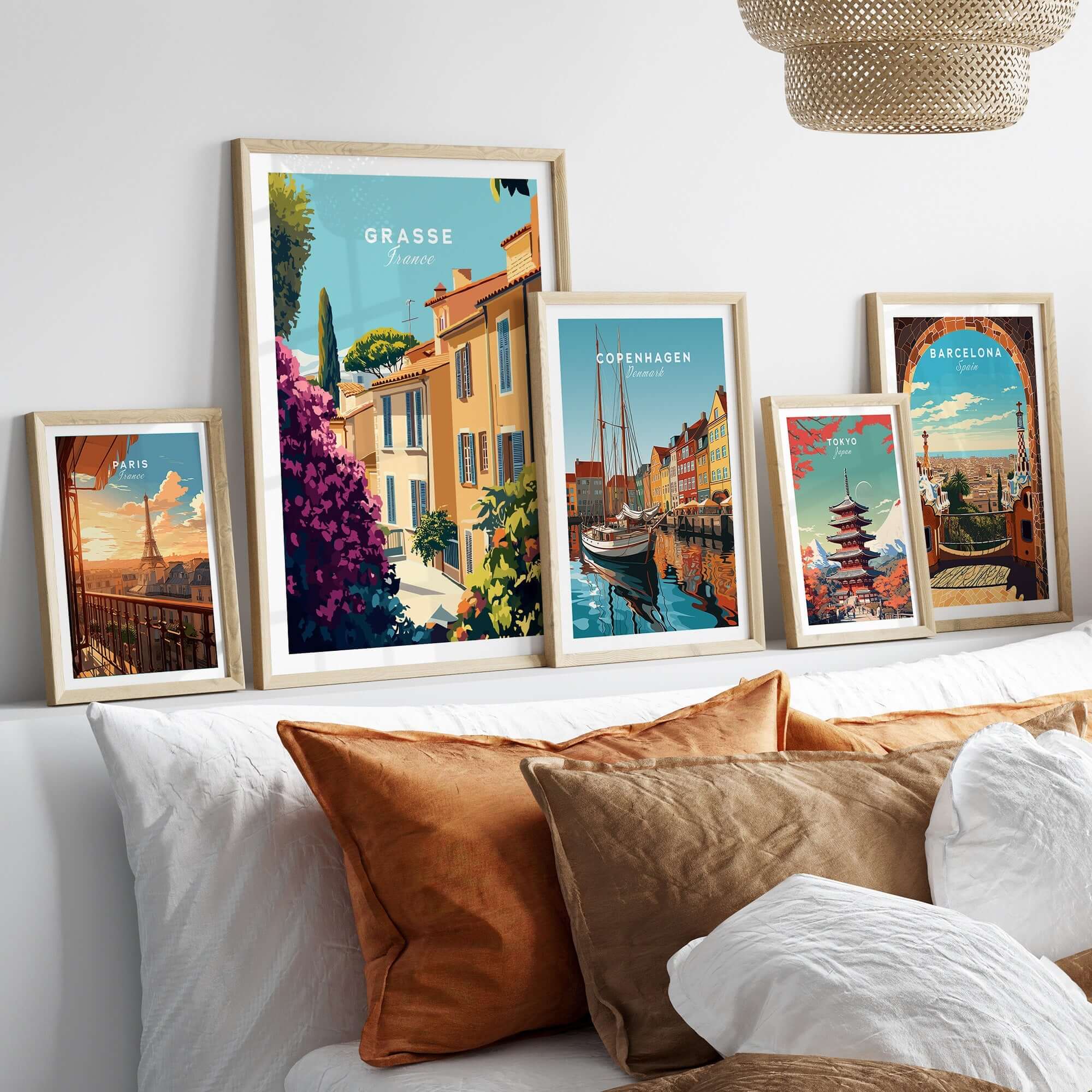 Grasse France Wall Art collection displayed on a stylish bed, showcasing vibrant European landscapes.