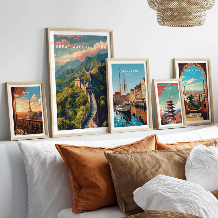 Great Wall of China Ancient Wonder Poster displayed with other scenic travel art prints on a stylish bed.
