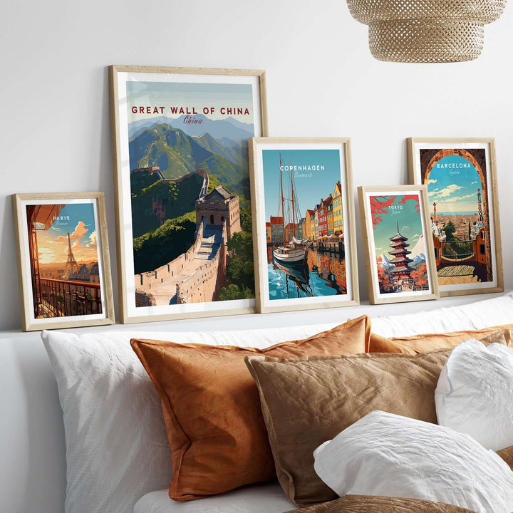 Collection of travel posters including The Great Wall of China, Copenhagen, and Barcelona on a decorative wall.