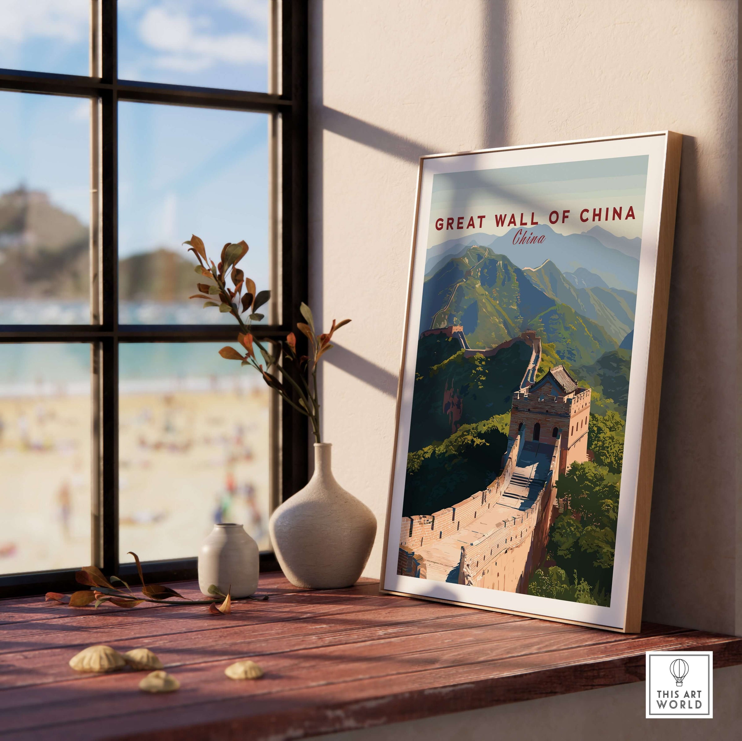 The Great Wall of China Art Print - Scenic Landscape Travel Poster displayed on a wooden table near a window.