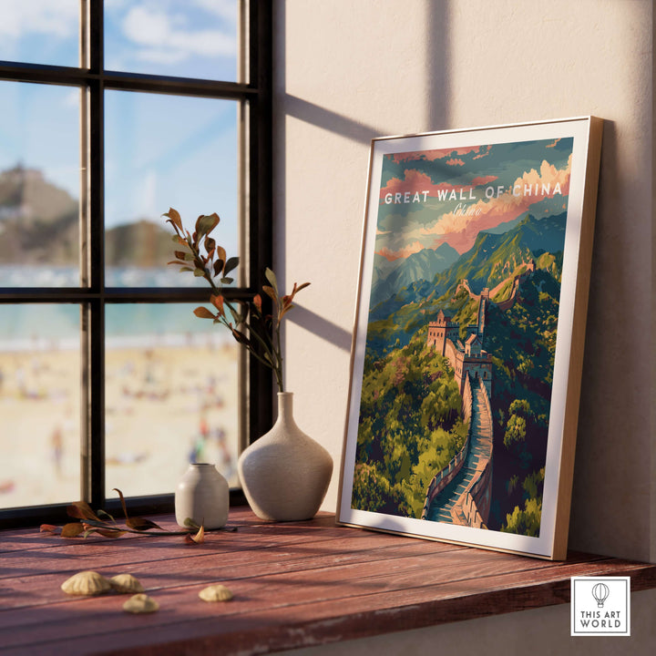 Great Wall of China poster framed on a windowsill showcasing majestic mountains and ancient architecture.