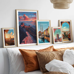 Great Wall of China Sunset Travel Poster - Vibrant Mountain Landscape Print displayed among other travel posters on a stylish bed.