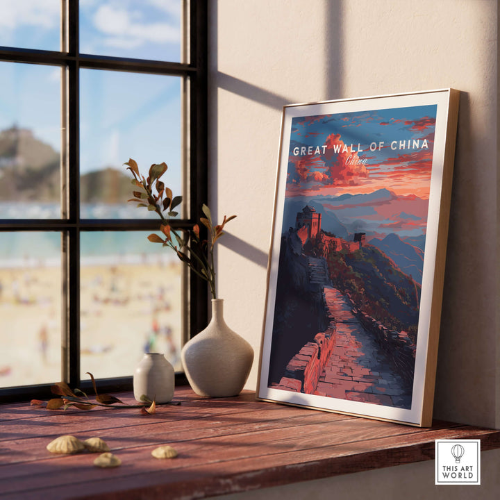 Great Wall of China sunset travel poster framed near a window with vibrant mountain landscape design.
