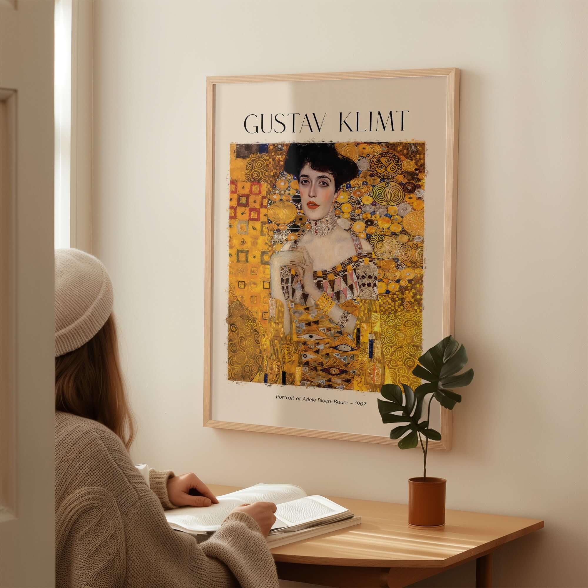 Gustav Klimt Art Print - Portrait of Adele Bloch-Bauer I Poster 1907 displayed in a cozy interior with a woman studying.