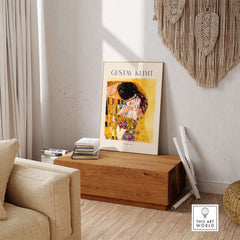 Gustav Klimt Art Print - The Kiss 1907 displayed in a stylish interior setting, highlighting its romantic elegance.