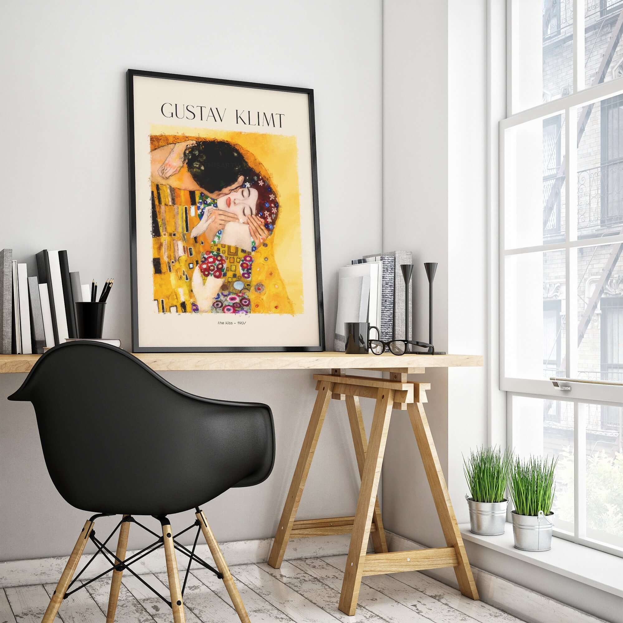 Gustav Klimt Art Print - The Kiss 1907 displayed on a stylish desk with modern decor and plants.