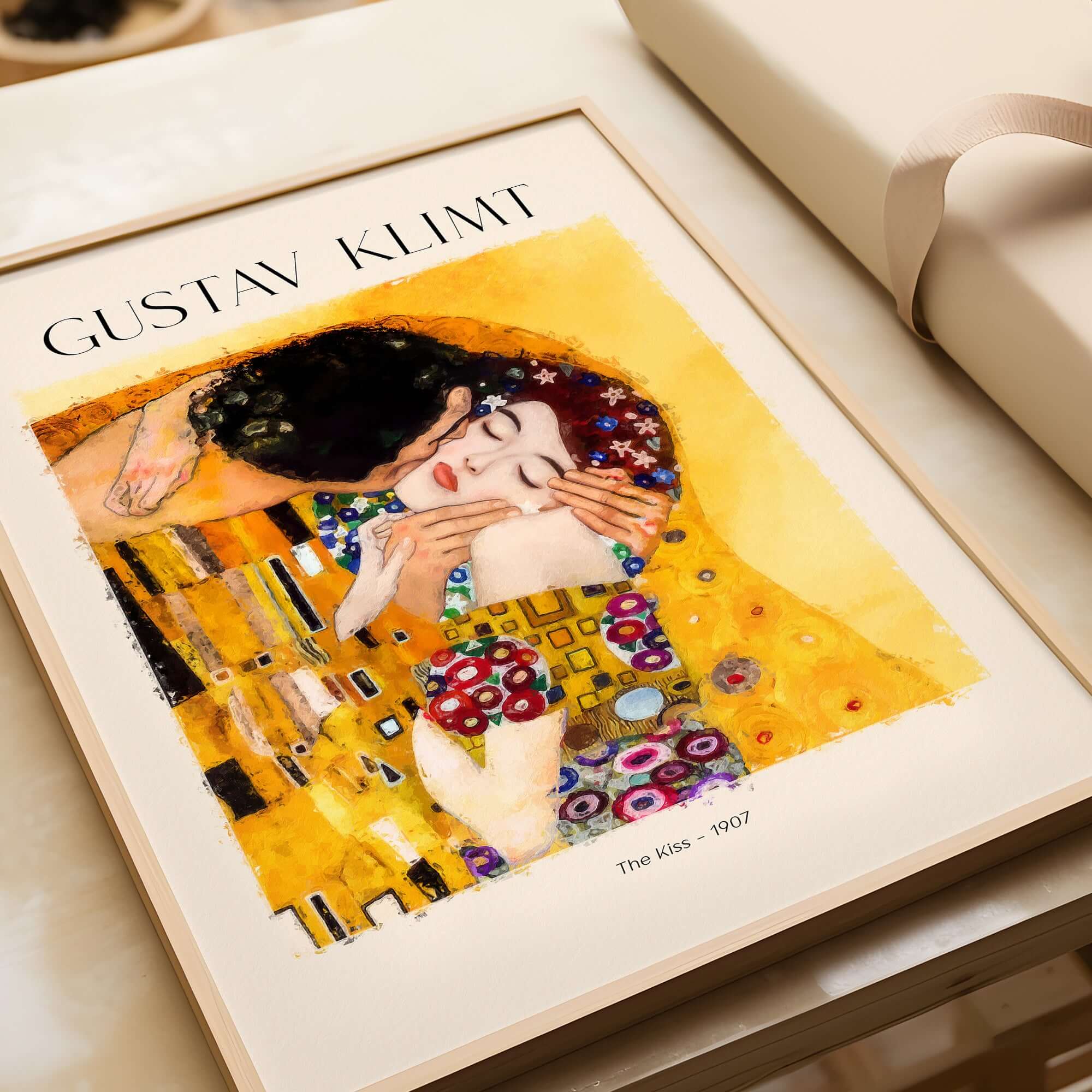 Gustav Klimt Art Print - The Kiss 1907 showcased on a table with elegant packaging.