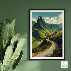 Ha Giang Loop Vietnam Mountain Road Travel Poster Print Landscape Wall Art framed on a green wall with tropical leaves.