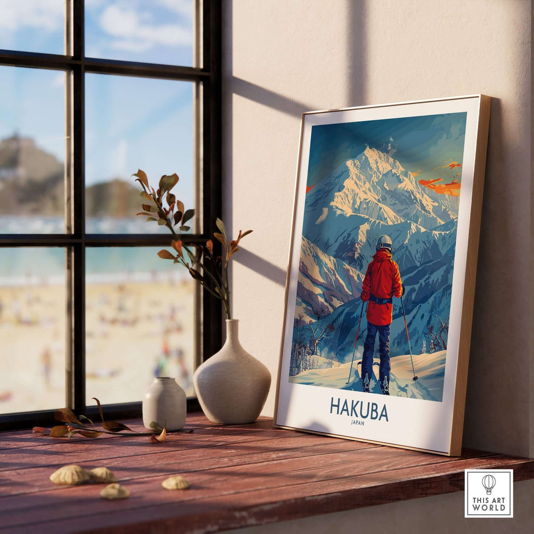 Hakuba wall art print displayed by window, featuring snowy mountains in Japan, with a skier in red jacket, perfect for home decor.