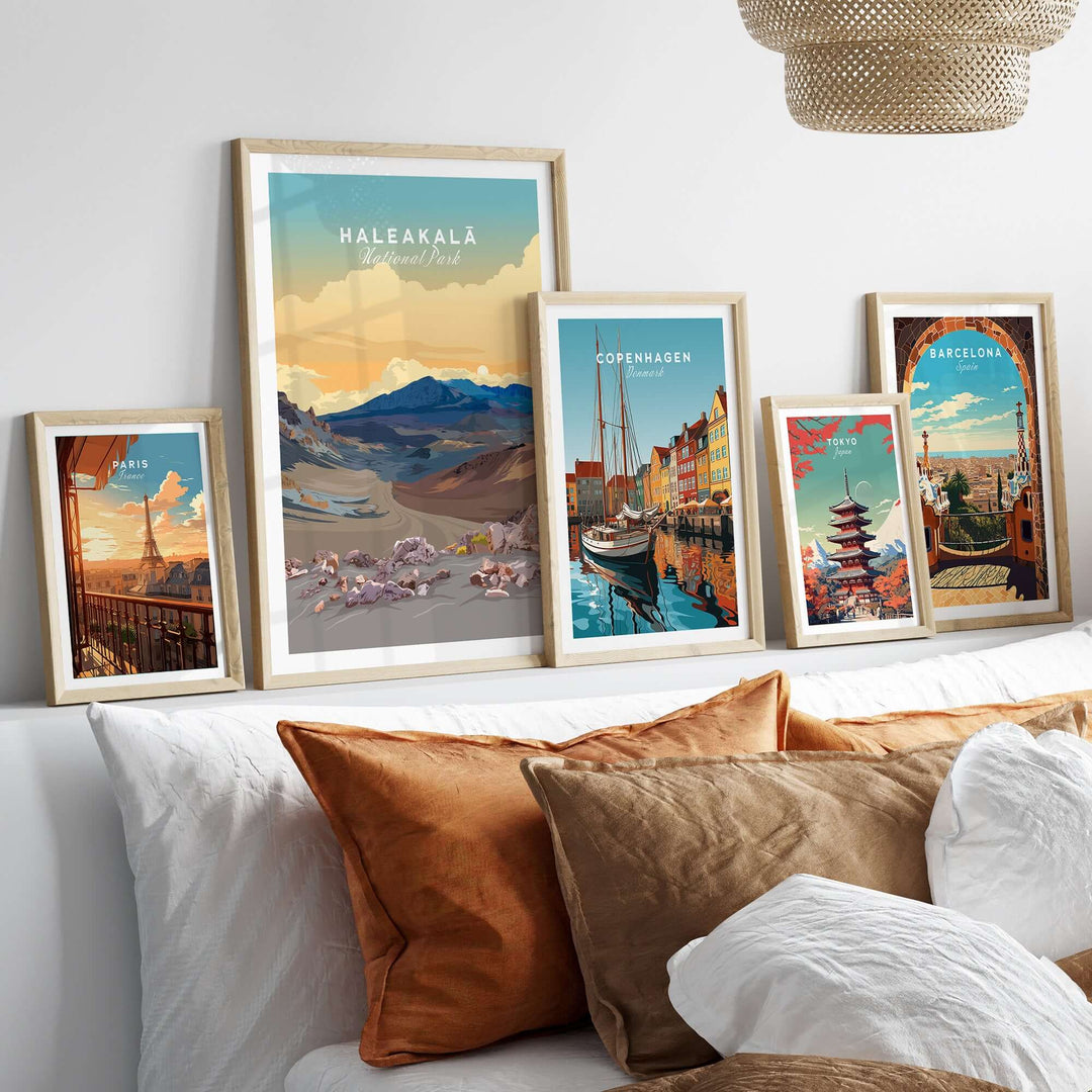 Haleakalā Volcano poster and travel prints from various cities displayed on a cozy sofa.