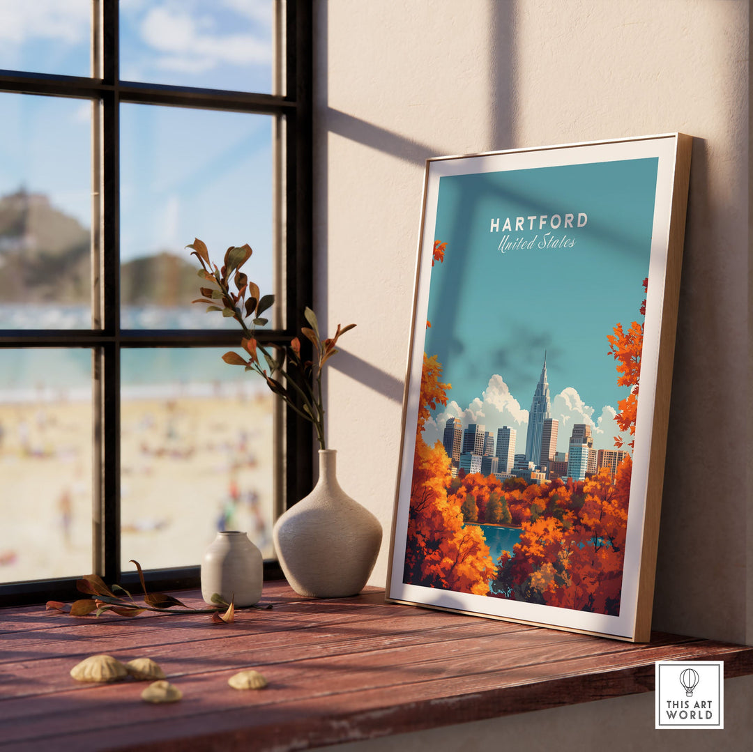 Hartford skyline poster with autumn leaves on a windowsill, featuring vibrant cityscape under a blue sky.