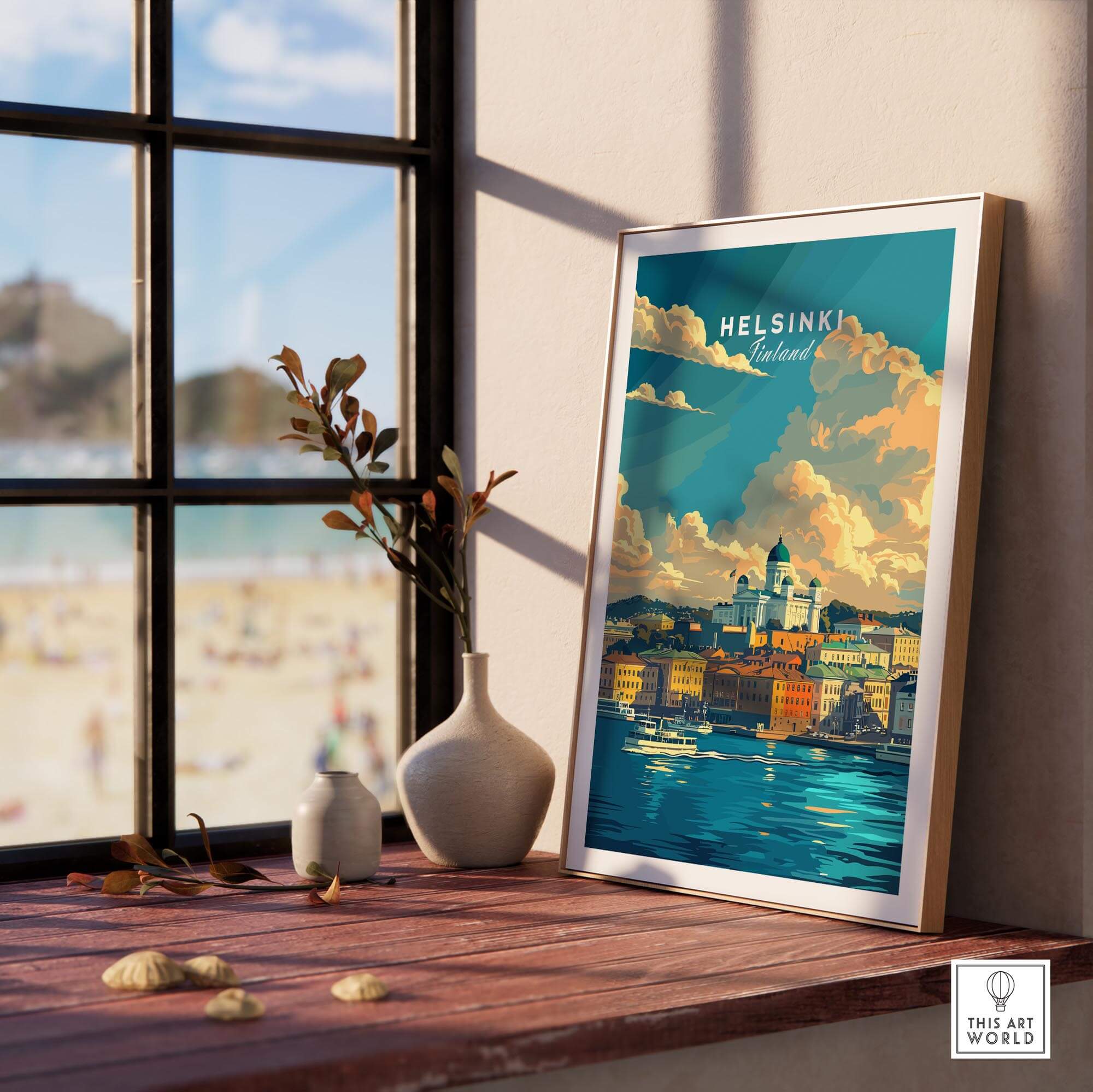Helsinki Travel Print - Finland in a stylish frame on a wooden table near a window with a beach view.
