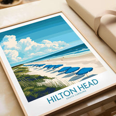 Hilton Head Travel Poster featuring a scenic beach view with blue umbrellas and coastal beauty.