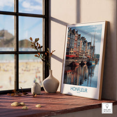 Honfleur Poster - Normandy France Travel Print - Boats and Buildings Wall Art displayed on a wooden table by the window.