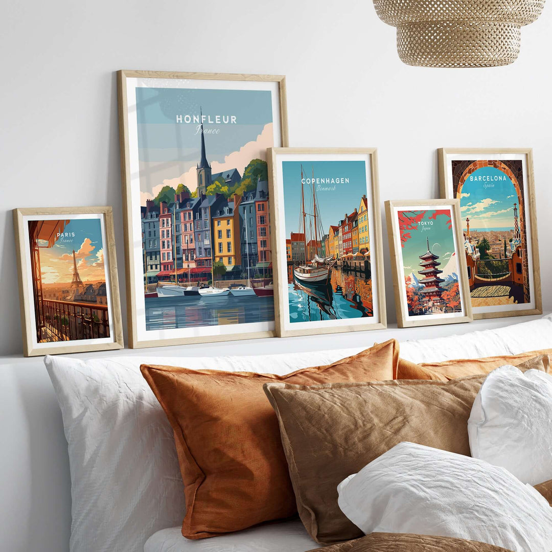 Framed Honfleur harbor scene poster and travel art prints on a stylish living room wall.