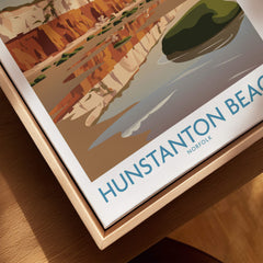 Hunstanton Beach Norfolk Poster | British Seaside Landscape Canvas Print displayed on a modern wooden table.