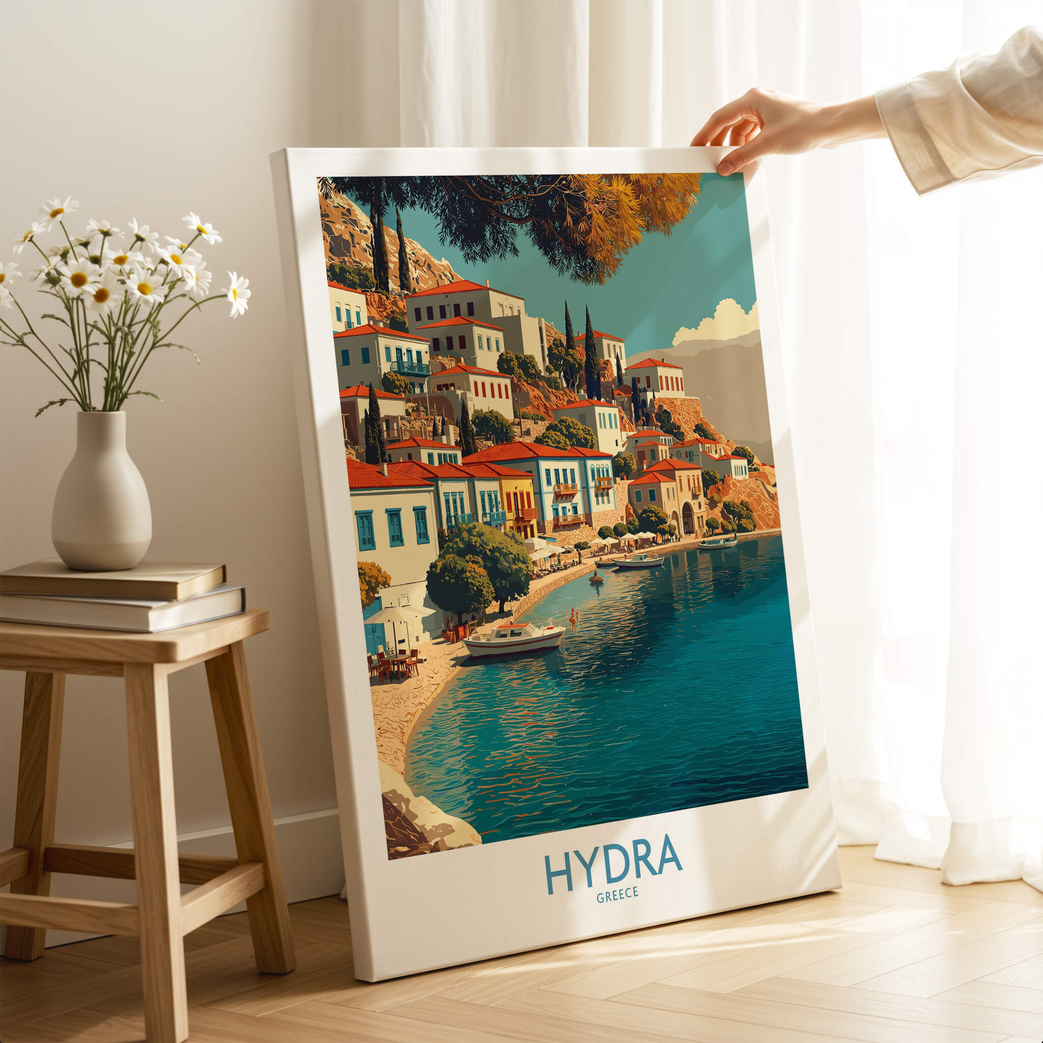 Hydra Greece Canvas Print | Mediterranean Seaside Town Poster displayed on a table, showcasing colorful waterfront buildings.