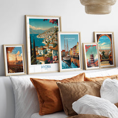 Hydra Greece Poster | Greek Island View Canvas Print displayed among framed art on a stylish sofa.