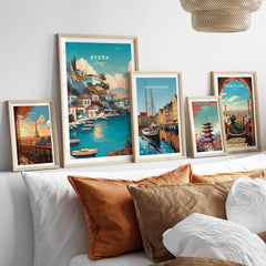 Hydra Greece Travel Poster | Waterfront Village Wall Art Print displayed with other travel posters in a cozy living room decor.