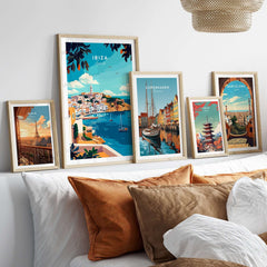 Ibiza Travel Print collection showcased in stylish frames on a cozy sofa, adding vibrant travel artwork to home decor.