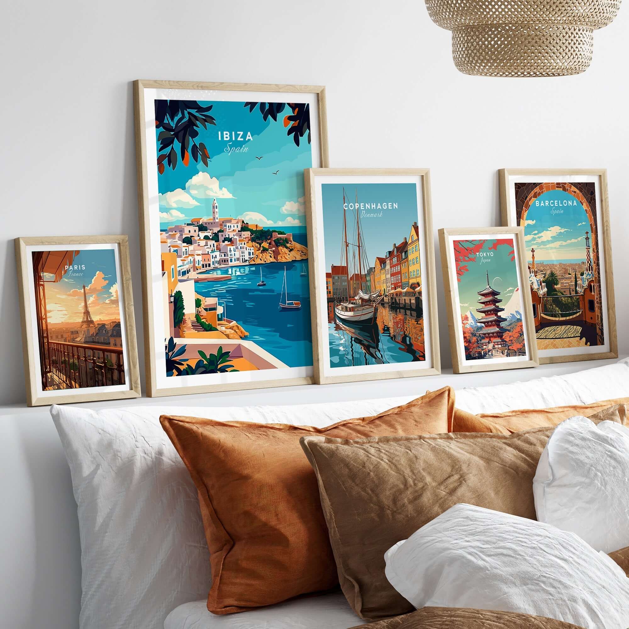 Ibiza Travel Print collection showcased in stylish frames on a cozy sofa, adding vibrant travel artwork to home decor.