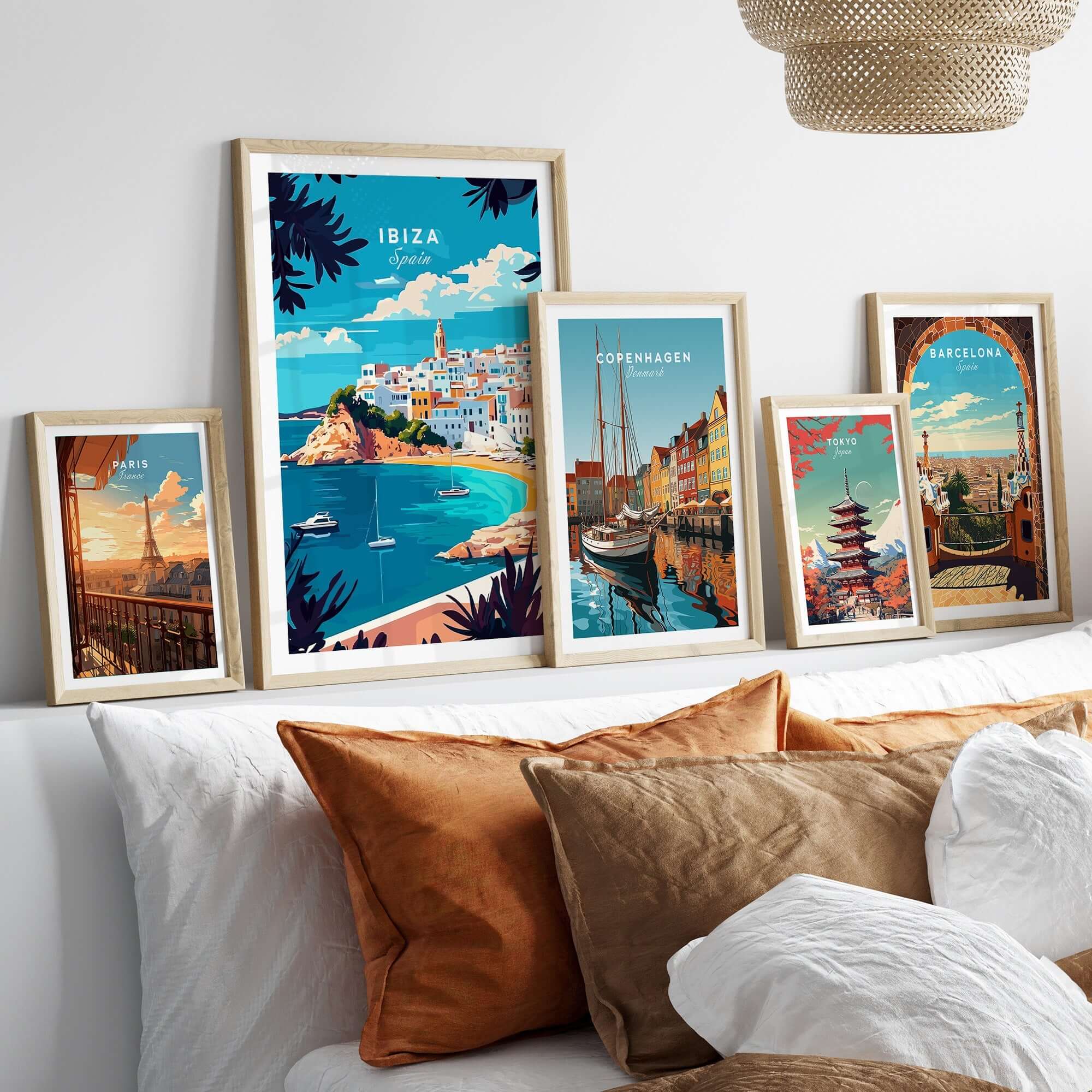 Ibiza Wall Art collection featuring vibrant Spain travel posters in stylish frames on a cozy bed.
