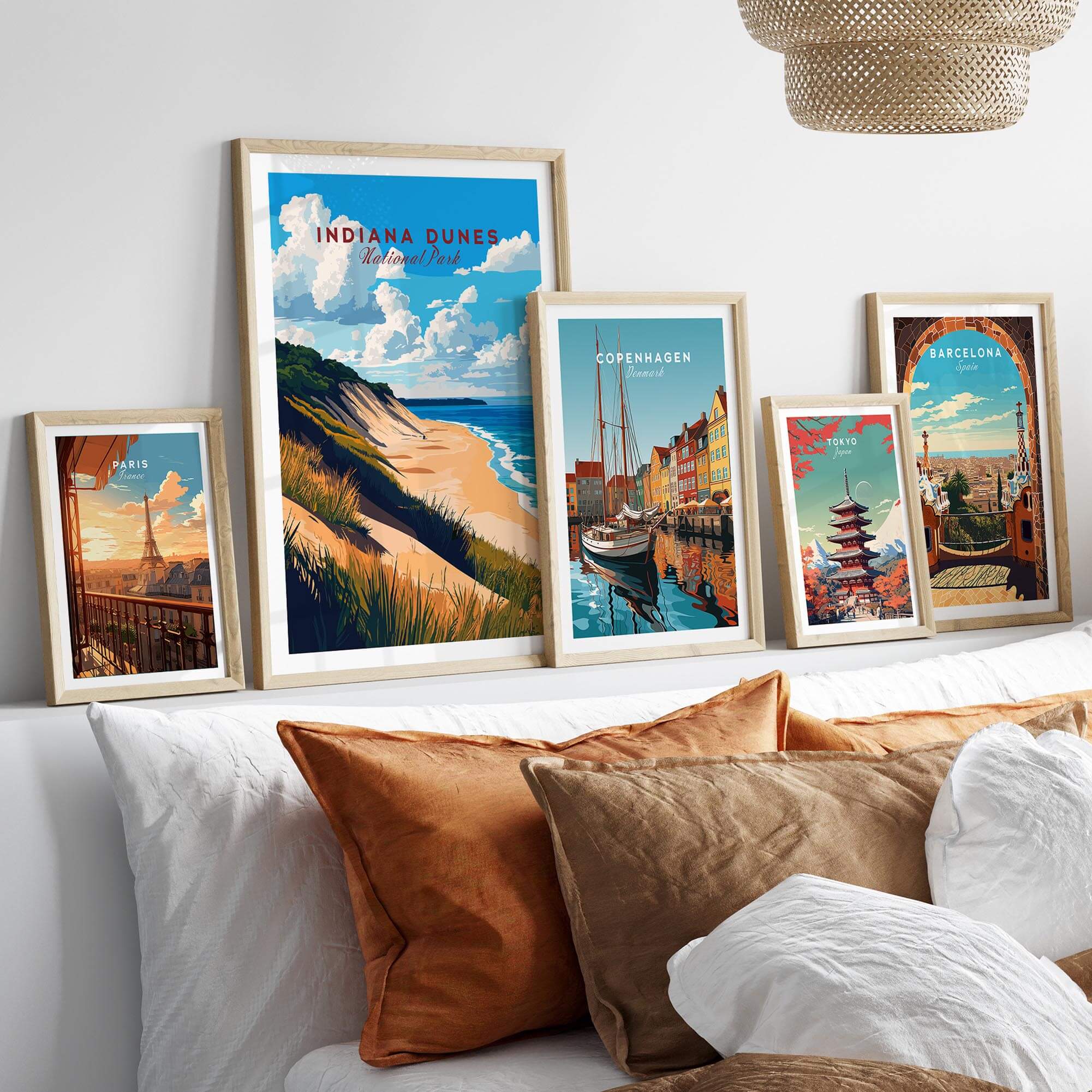 Indiana Dunes Wall Art displayed among other framed artwork on a stylish bed with cozy pillows.