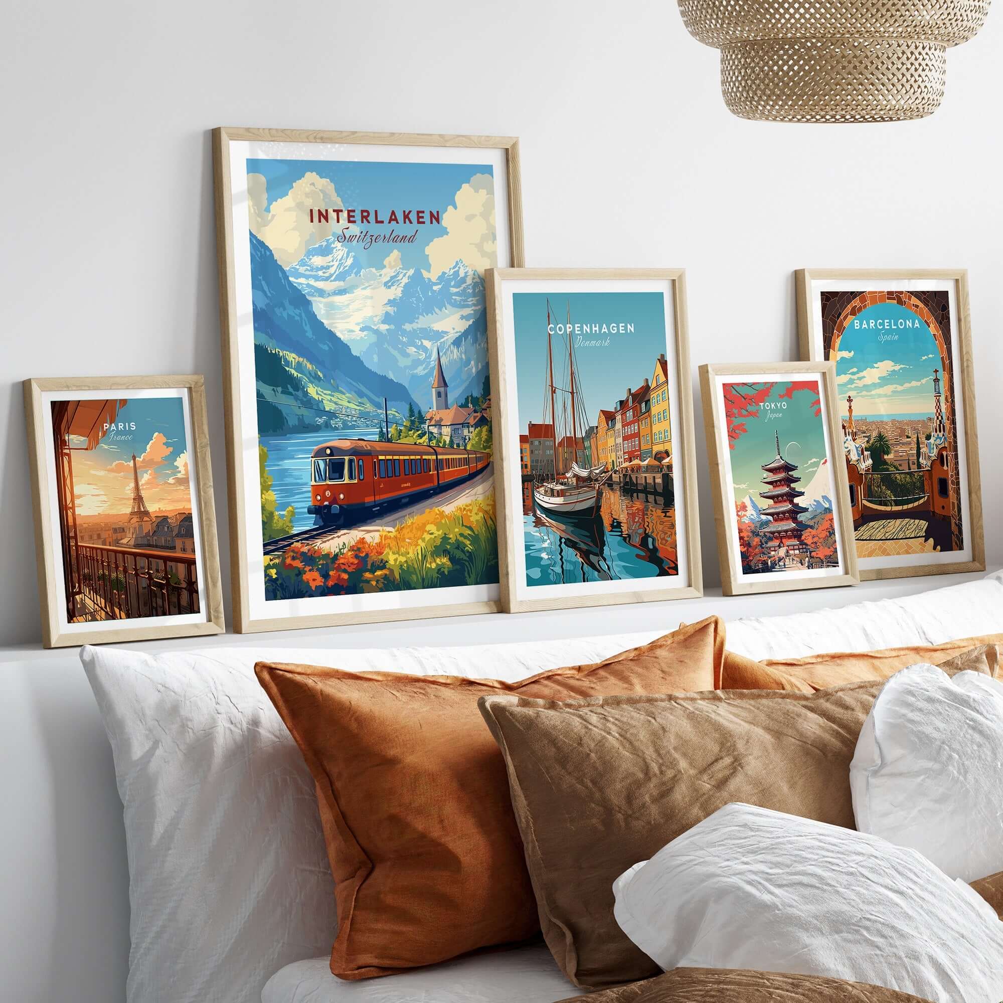 Interlaken Travel Print displayed among other travel prints on a stylish sofa, highlighting beautiful landscapes and cities.