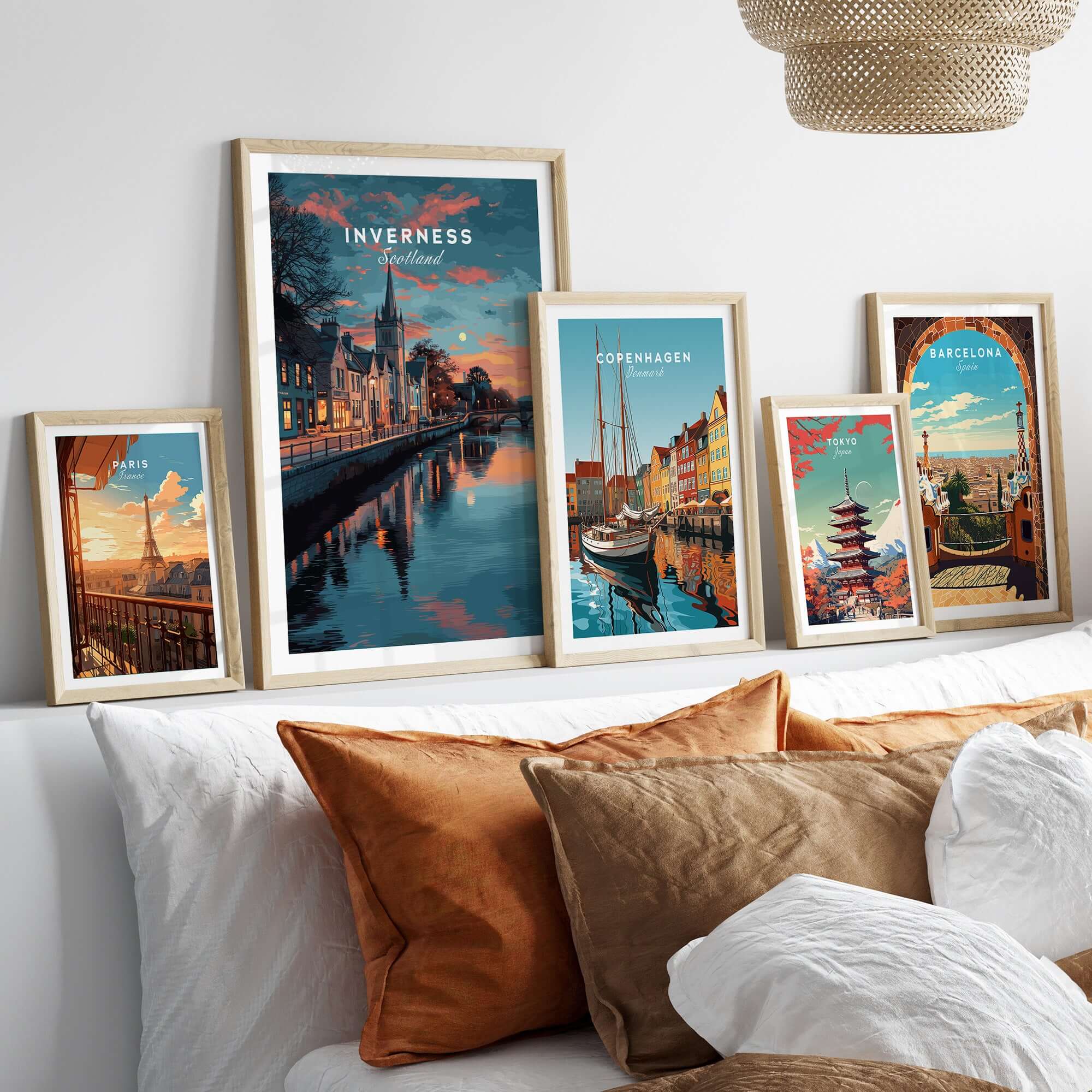 Inverness Print | Highland Wall Decor showcasing framed art of Inverness and other cityscapes on a stylish couch.