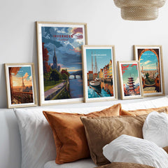 Inverness Print | Scottish Cityscape Wall Art displayed among other travel artworks on a stylish sofa.