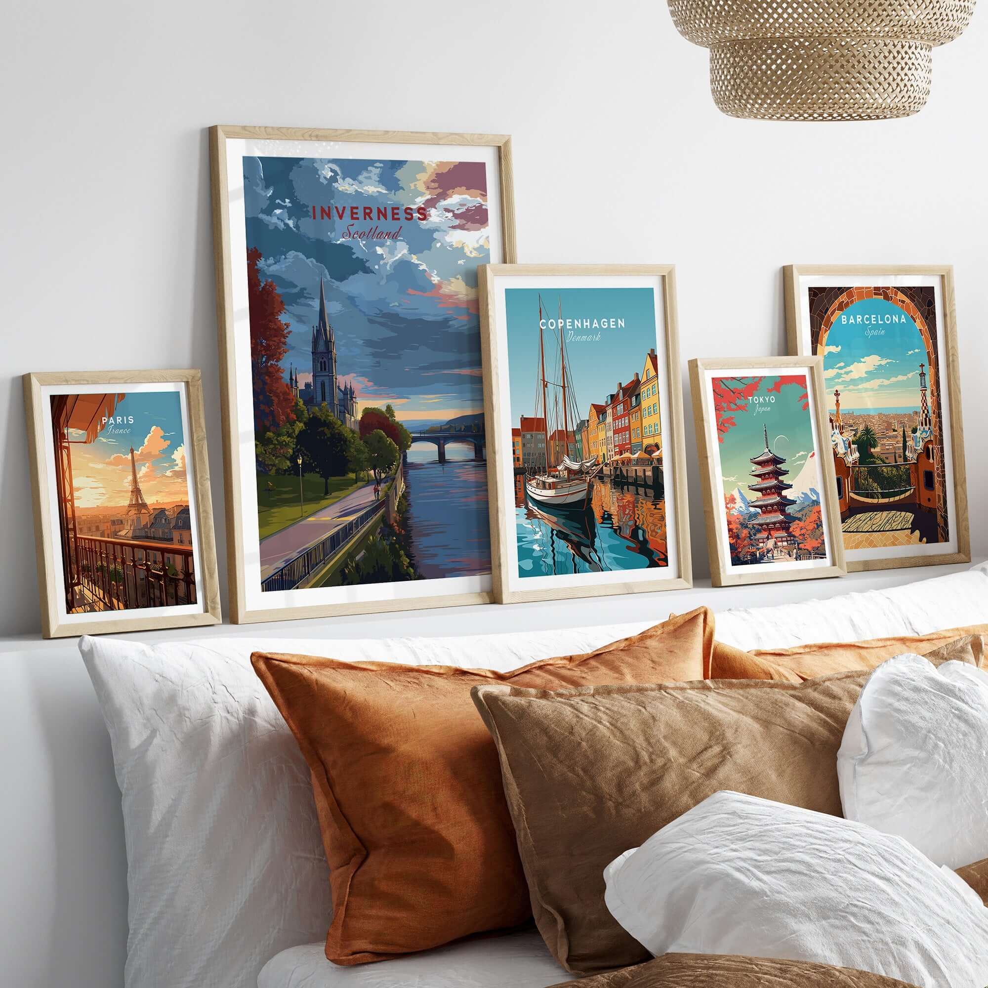 Inverness Print | Scottish Cityscape Wall Art displayed among other travel artworks on a stylish sofa.