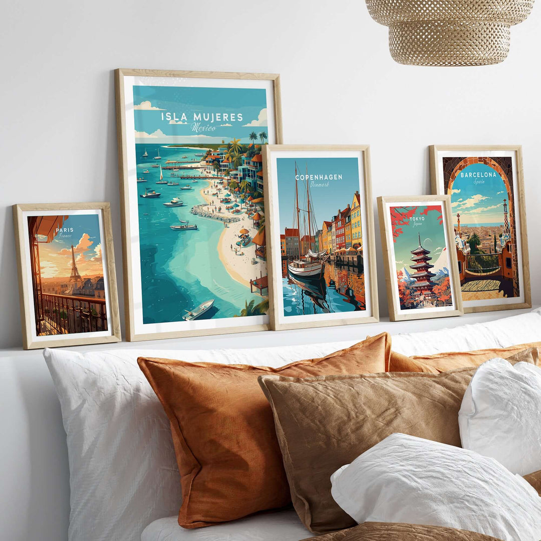 Framed Isla Mujeres beach scene poster among other vibrant travel posters in a cozy home decor setting.