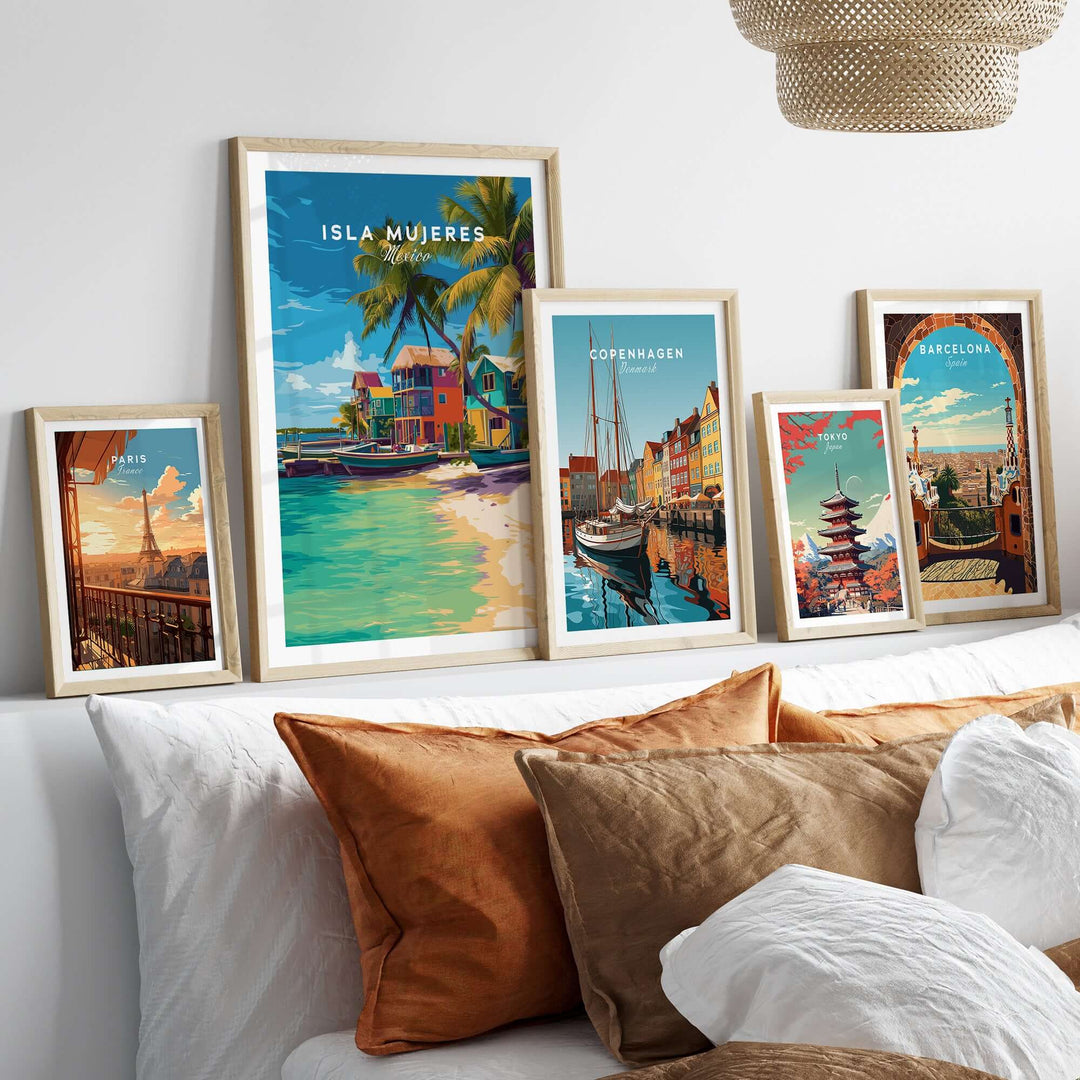 Collection of vibrant travel prints featuring Isla Mujeres and various cities, displayed on a stylish wall decor setup.
