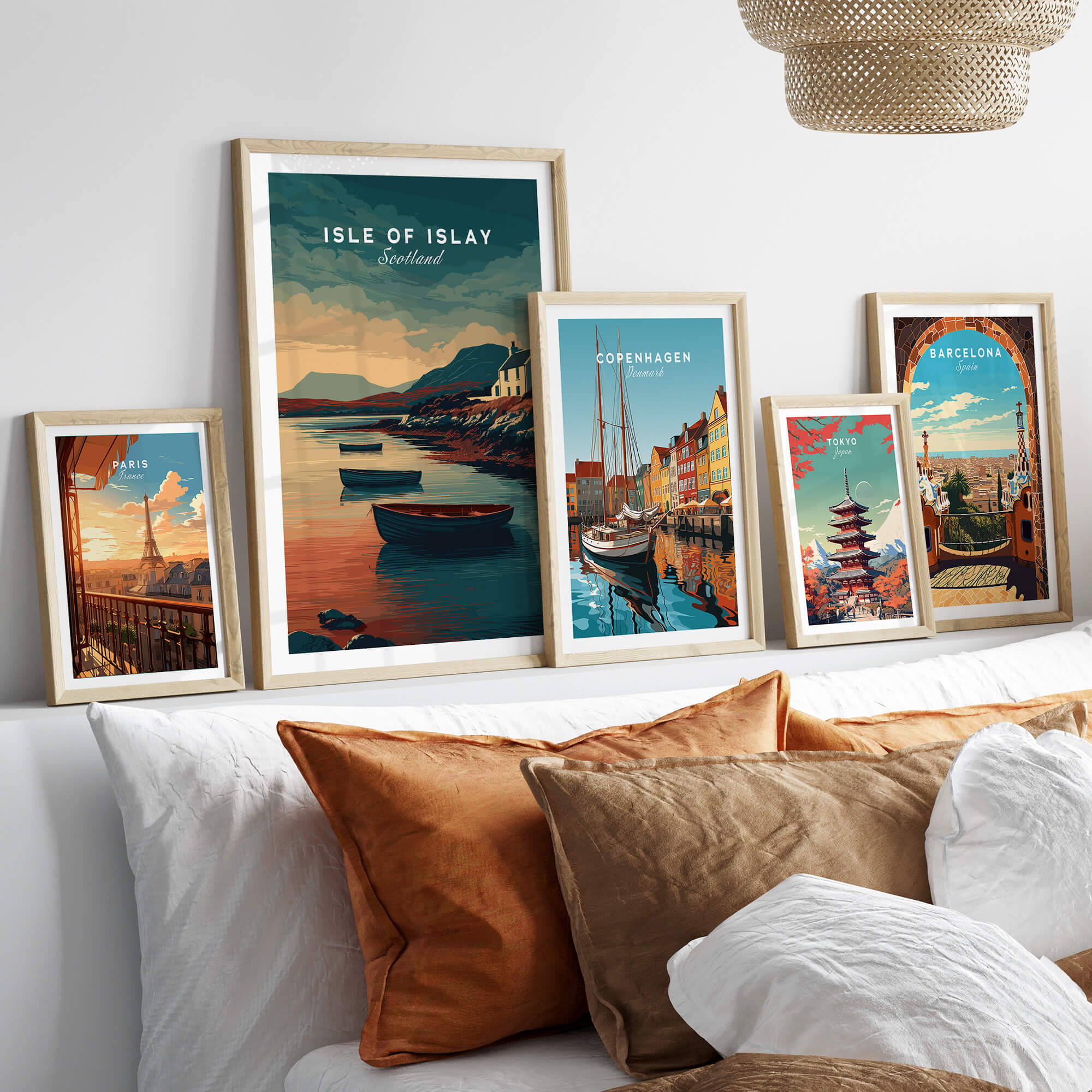 Isle of Islay Scotland Wall Art Print | Coastal Boats Travel Poster displayed among other framed travel posters on a couch.