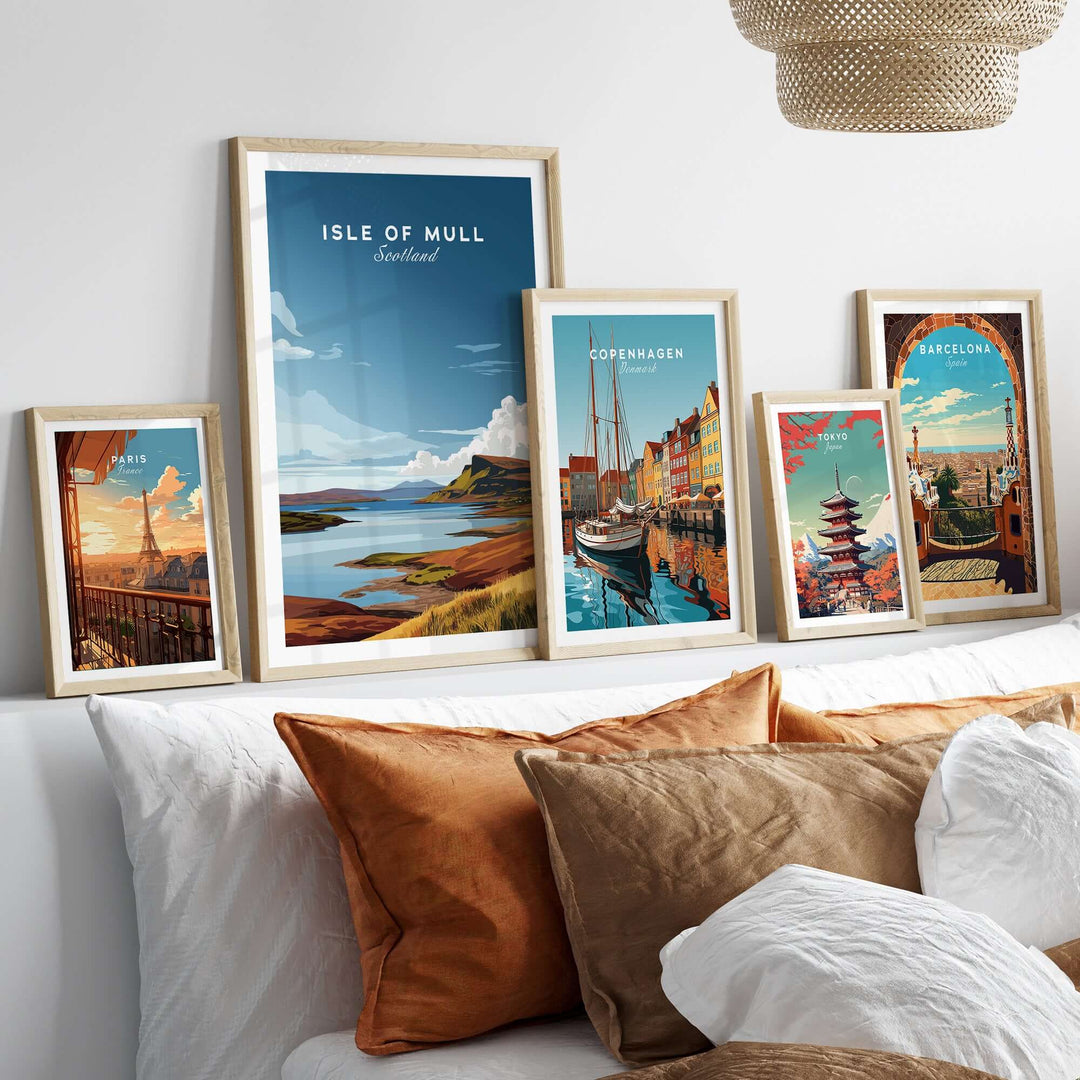 Framed Isle of Mull Scotland Coastal Panorama poster with other city prints on a decorative shelf.