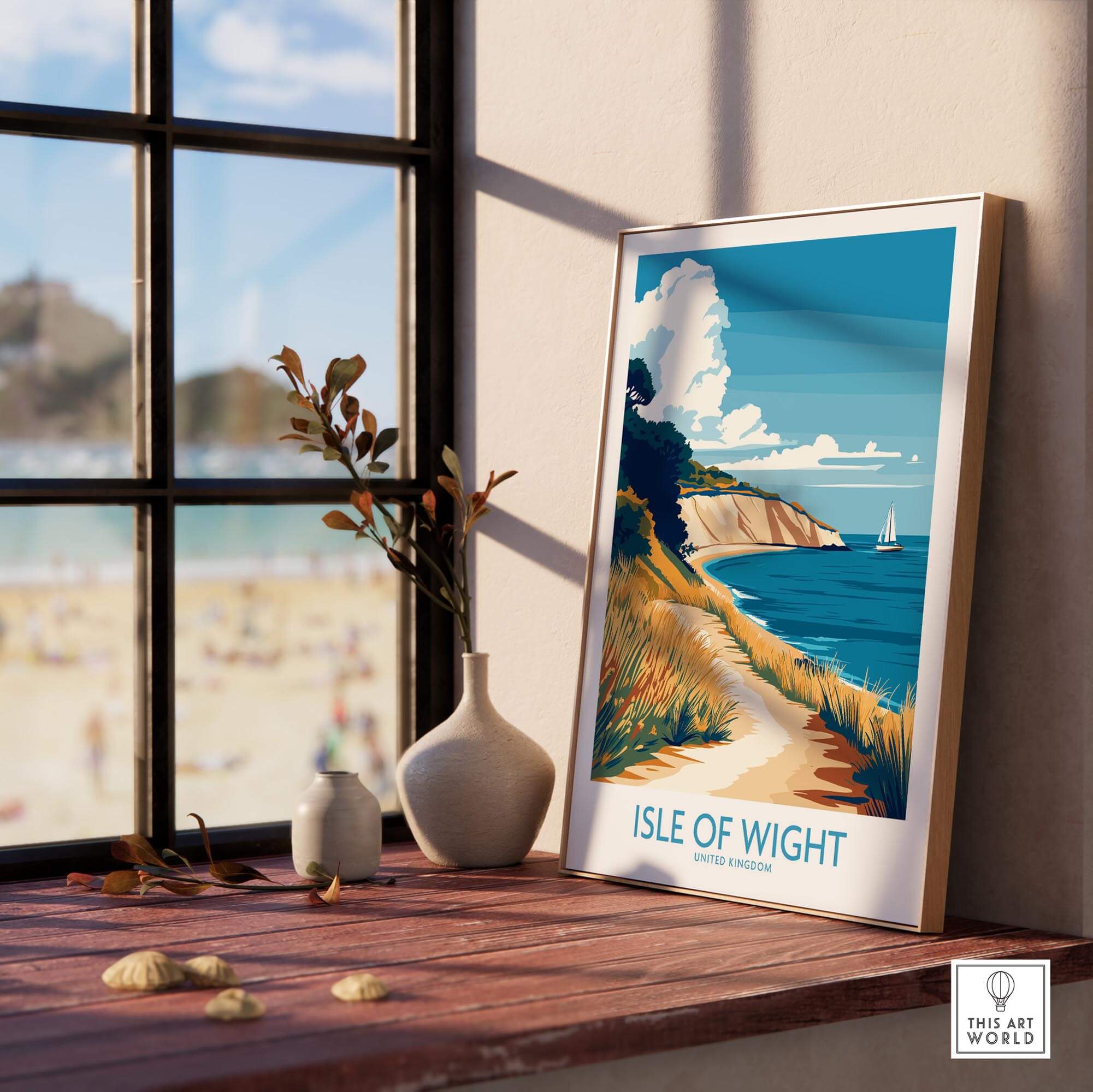 Isle of Wight England Poster displayed on a windowsill next to decorative items and a beach view.