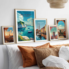 Isle of Wight Travel Print and other travel posters displayed on a stylish bed, adding wanderlust to home decor.