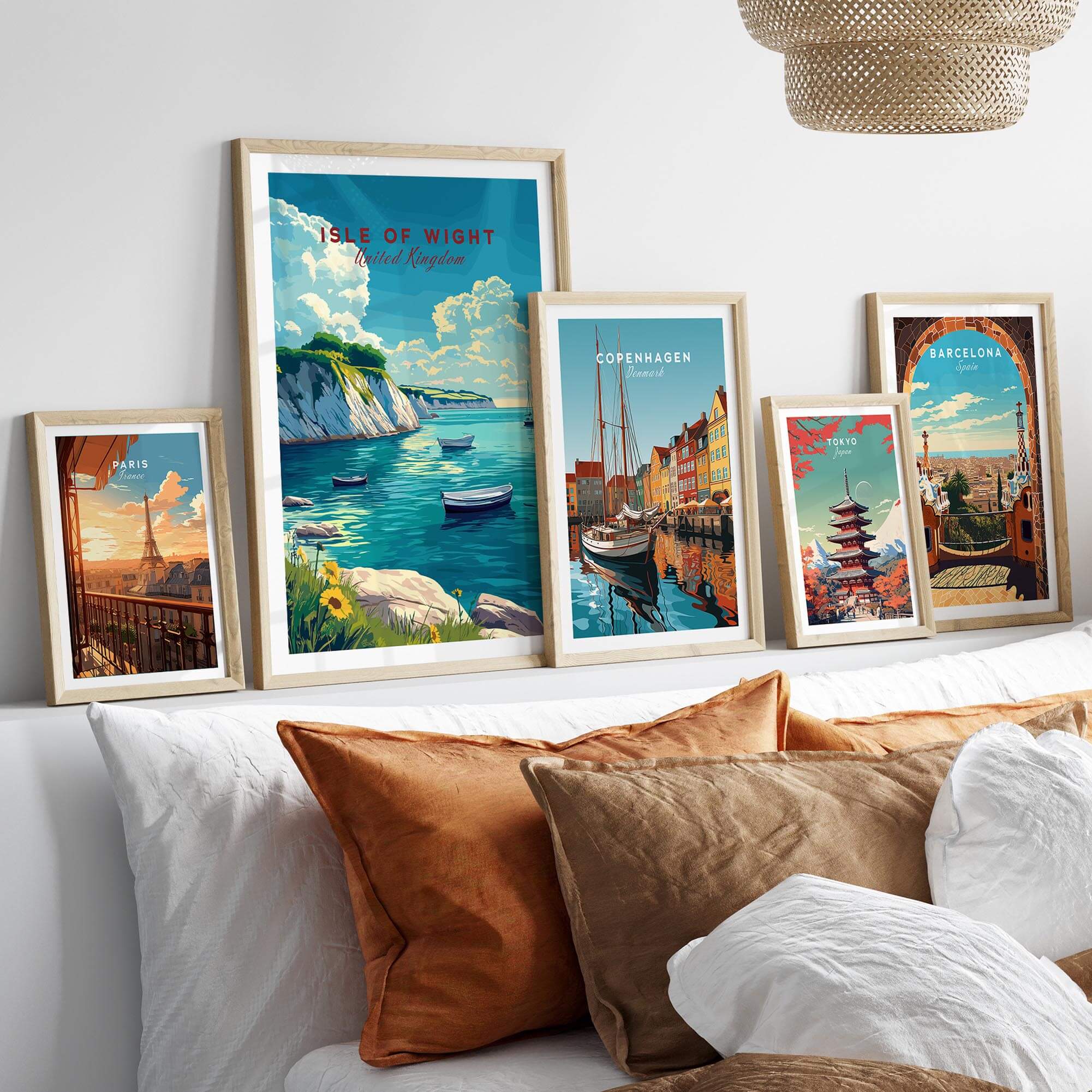 Isle of Wight Travel Print and other travel posters displayed on a stylish bed, adding wanderlust to home decor.
