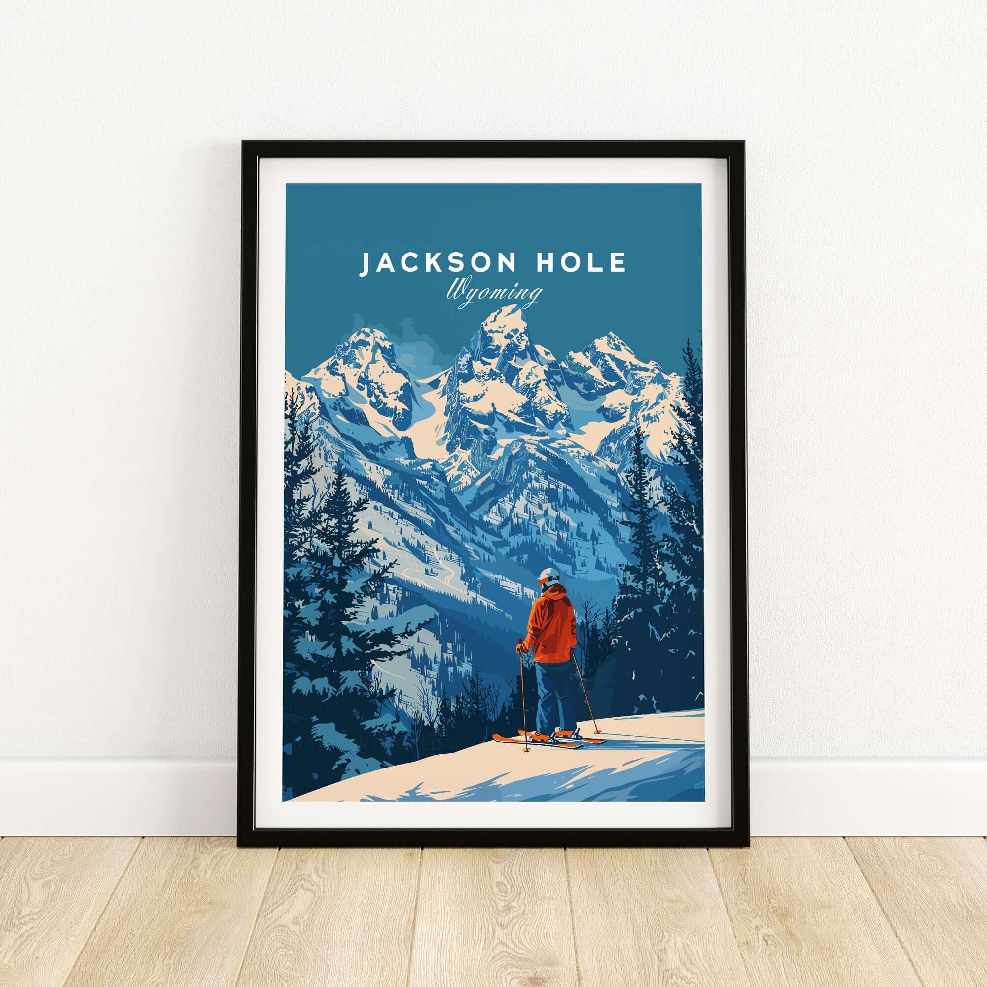 Jackson Hole Ski Poster featuring a skier overlooking snowy mountains in Wyoming, framed and displayed against a light wall.