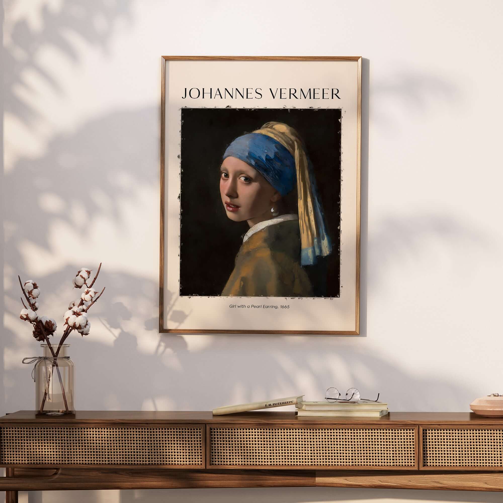 Johannes Vermeer Girl with a Pearl Earring 1665 Iconic Dutch Portrait Art Print framed on a wall above a wooden table.