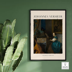 Johannes Vermeer Lady Seated at a Virginal 1670 Dutch Golden Age Art Print framed on a green wall with plants.