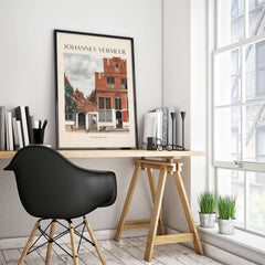 Johannes Vermeer The Little Street 1657 Delft Scene Dutch Golden Age Art Print framed on a desk in a modern interior.