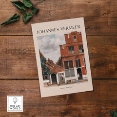 Johannes Vermeer The Little Street 1657 Delft Scene Dutch Golden Age Art Print on wooden table.