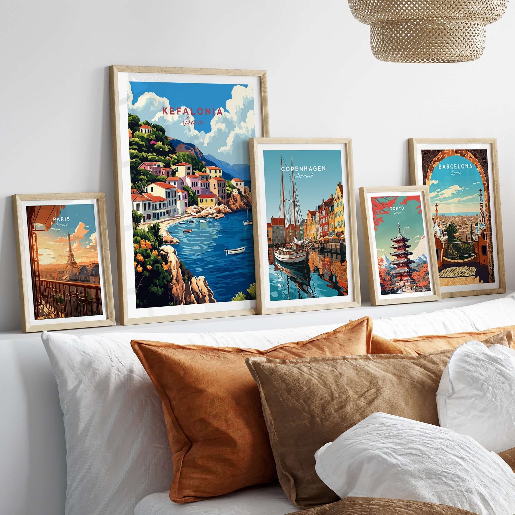 Kefalonia Art Print displayed among other travel posters on a modern sofa, showcasing vibrant landscapes.