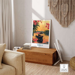 Kerala Poster India displayed in a cozy living room setting, featuring a beautiful sunset and tranquil boat scene.